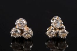 A pair of diamond trefoil cluster earrings: each set with circular,