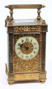 An Edwardian French brass carriage clock with filigree panels: the eight-day duration timepiece