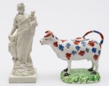 A Cambrian pottery cow creamer and a Ralph Wood type figure: the former modelled standing four