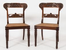 A set of four Regency Colonial carved rosewood dining chairs:,