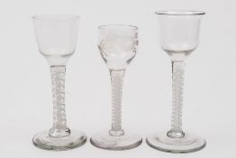 Three opaque twist wine glasses: comprising two with ogee shaped bowls on straight stems one with