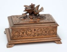 A late 19th century linden wood Black Forest jewellery casket:, of rectangular outline,