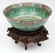 A Cantonese porcelain punch bowl: the interior decorated in the famille verte palette with a