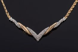A diamond mounted two-colour 'V'- shaped necklace: with circular,
