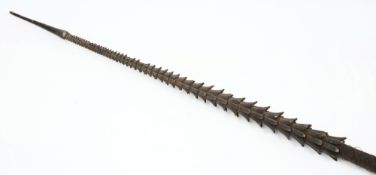 A Polynesian carved wood fish spear:, the cord bound shaft with graduated barbs, 362 cm.