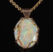 An oval opal single stone pendant: the opal approximately 25mm long x 19mm wide,