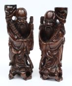 A pair of Chinese carved rootwood figures of Immortals: with inset shell eyes and teeth,
