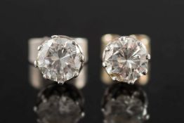 A pair of diamond single-stone ear studs: each with a circular,
