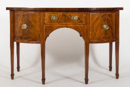 WITHDRAWN
A George III mahogany and inlaid bow-fronted sideboard:, crossbanded in kingwood,
