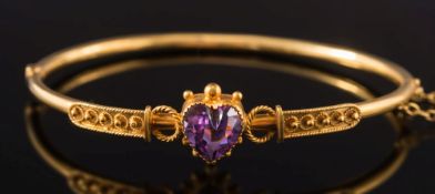 A 9ct gold and heart-shaped amethyst mounted hinged bangle:.
