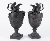 Two Wedgwood 'Sacred to Bacchus' black basalt wine ewers: in neo-classical style after a design by