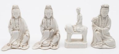 A group of four Chinese blanc de Chine figures: including three seated figures of Guanyin wearing