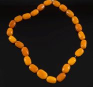 A graduated amber bead, single string necklace: comprising 25 oblong beads,
