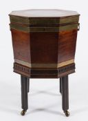 A George III mahogany and brass bound octagonal wine cooler on a stand:,