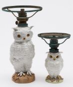 A French porcelain 'owl' table lamp and one similar: both with glass eyes and on mound bases,