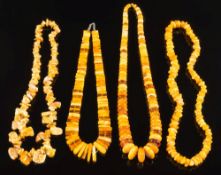 Four Amber bead mounted necklaces: of natural unheated Baltic amber and other beads.