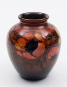 A Moorcroft pottery flambé vase: of oviform tubelined in the Poppy pattern in red, purple,