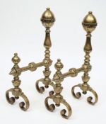 A pair of 18th century Dutch brass andirons:, with floral decorated acorn finials, on knopped stems,
