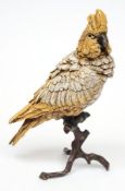 A Bergman cold painted bronze model of a yellow and white Cockatoo: perched on a naturalistic stump,
