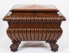 An early Victorian gadrooned mahogany wine cooler:, of sarcophagus outline,
