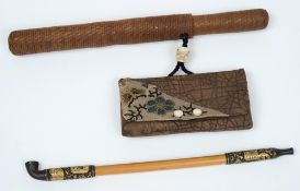 An early 20th Century Japanese bamboo and metal mounted opium pipe:, in a woven wicker case,