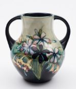 A Moorcroft pottery vase: of pear shaped two handled form,