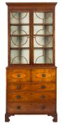 A George IV mahogany and inlaid secretaire bookcase:, the upper part with a moulded dentil cornice,