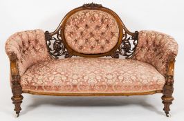 A Victorian carved mahogany settee:,