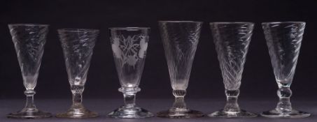 Five closely matched ale glasses and one other: the former of wrythen moulded trumpet shaped form