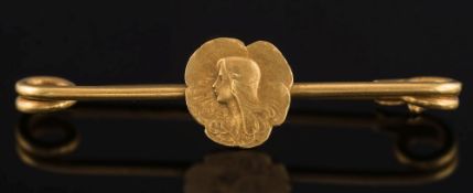 A late 19th century French gold pin brooch: with central female portrait panel.