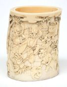 A Japanese carved ivory brush pot:, Meiji period, signed, the sides decorated with dancing oni's,