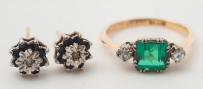 An emerald coloured doublet and diamond three-stone ring: with central square green doublet between