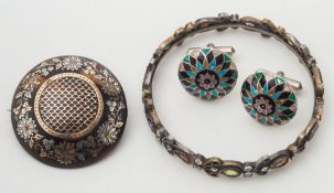 A coloured gemstone bangle and a tortoiseshell pique-work circular brooch and a pair of enamelled