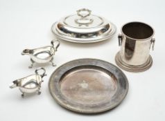 A  plated entree dish and cover : plated circular dish,  a wine cooler, and two plated sauce boats.