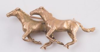 A 9ct yellow gold 'galloping horses' brooch:, approximately 20gms gross weight.