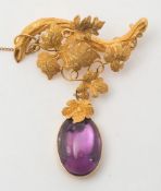 A late Victorian gold and foil backed cabochon amethyst brooch:,