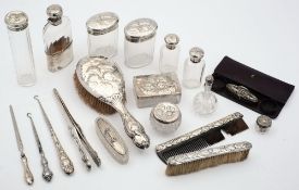 A silver mounted twelve piece dressing table set: decorated with heavenly children also five other