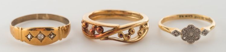 An 18ct gold openwork tapering band ring and two diamond-set rings:.