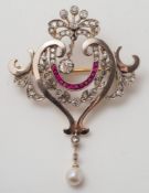 An early 20th century diamond and gem-set pendant brooch: of openwork foliate scroll design,