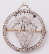 A circular diamond mounted brooch of pierced design: mille-grain set with rose diamonds and