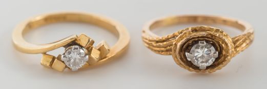 An 18ct gold and single diamond mounted ring of textured finish and a similar single diamond
