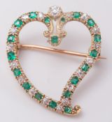A gold, diamond and emerald heart shaped brooch: with circular,