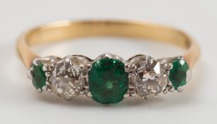An 18ct gold, emerald and diamond five stone ring:.