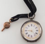 A lady's silver-cased open face pocket watch:, the dial with Roman numerals, on black velvet strap.