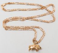 A gold 'Boar' pendant on gold curb-link chain:.