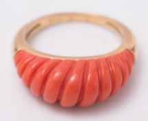 An 18ct gold and coral 'swirl' design ring:.