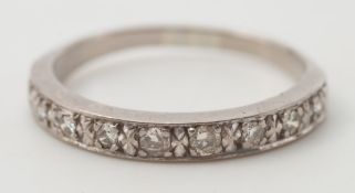 A diamond half eternity ring: with nine circular, brilliant-cut diamonds, ring size S.