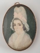 An oval portrait miniature depicting a woman: wearing a tall bonnet 50mm long.
