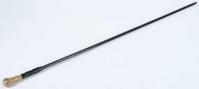 A carved hardwood and gold plated cane:.