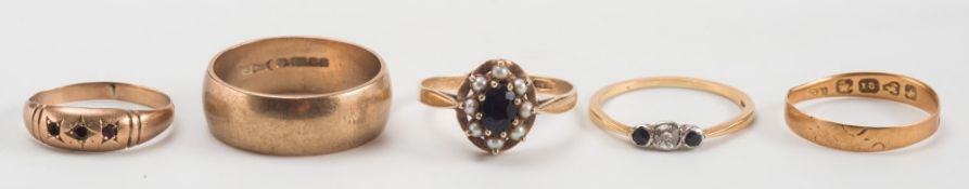 A gold, sapphire and diamond three-stone ring, a cluster ring and three gold rings:.